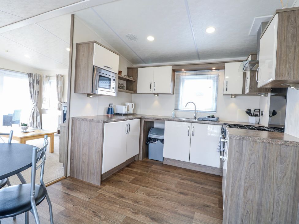 A kitchen with cabinets and appliances at 59 Cliff Field in Lowestoft