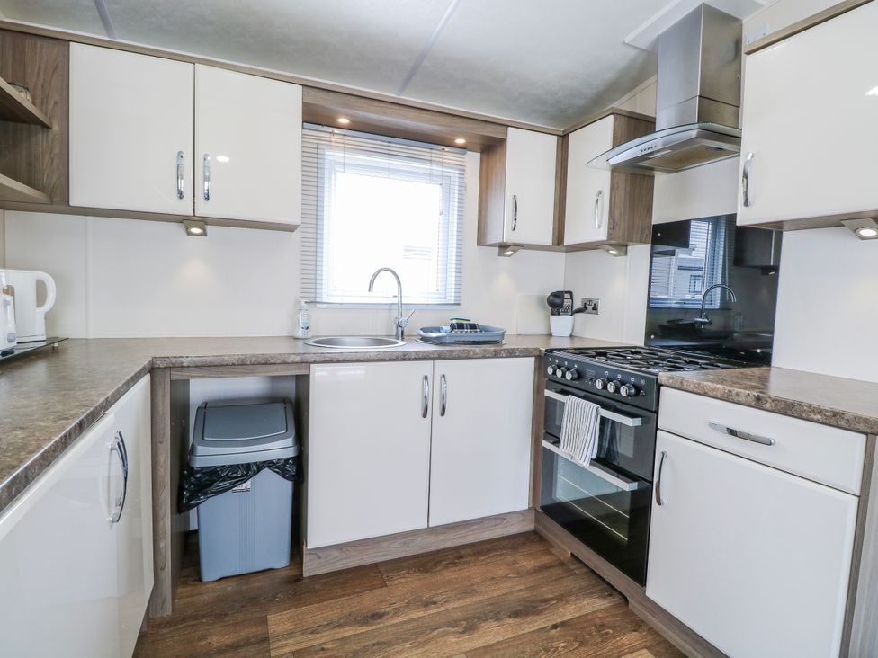 A kitchen with a sink and stove at 59 Cliff Field in Lowestoft