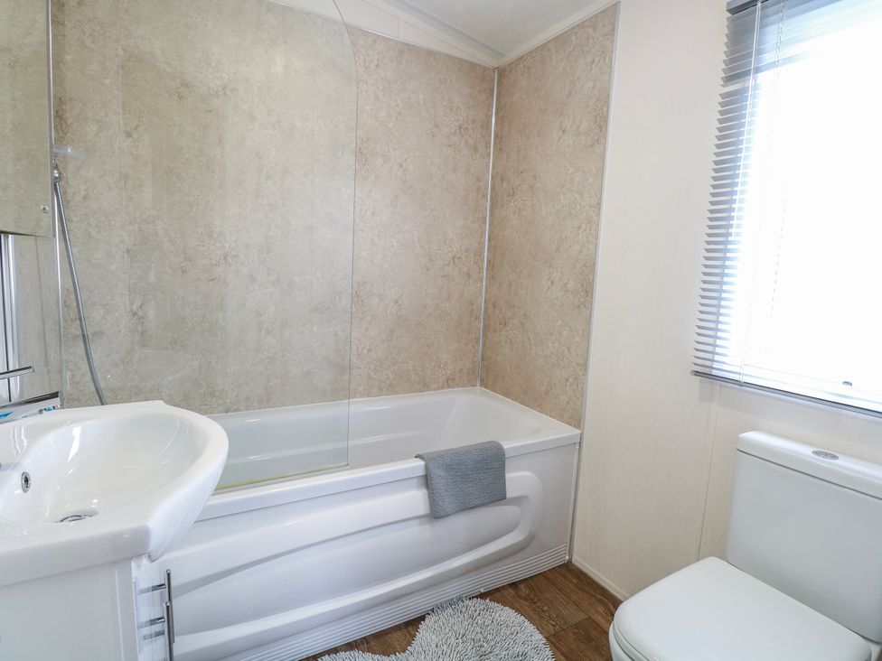 A bathroom with a bathtub, sink, and toilet at 59 Cliff Field, Lowestoft