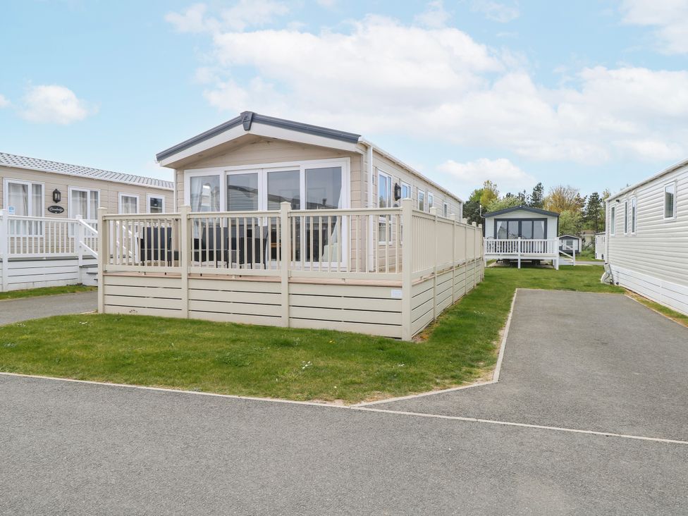 A mobile home with a deck and fence at 59 Cliff Field in Lowestoft