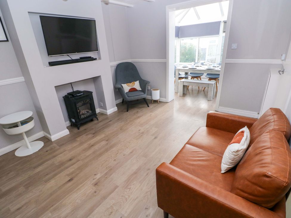 A living room with a television and sofa at The Wool Pack in Tenby