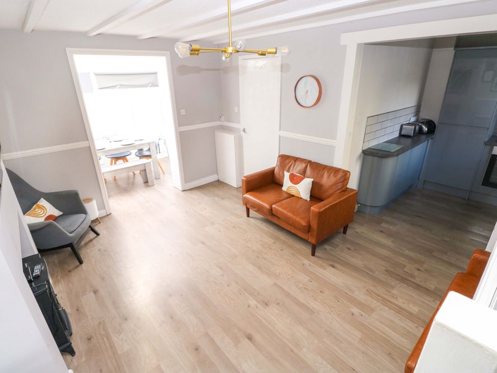 A living room with a sofa and chair at The Wool Pack in Tenby