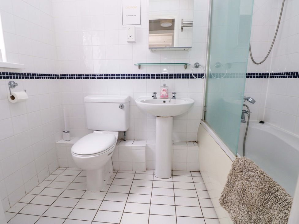 A bathroom with a toilet and sink at The Wool Pack in Tenby