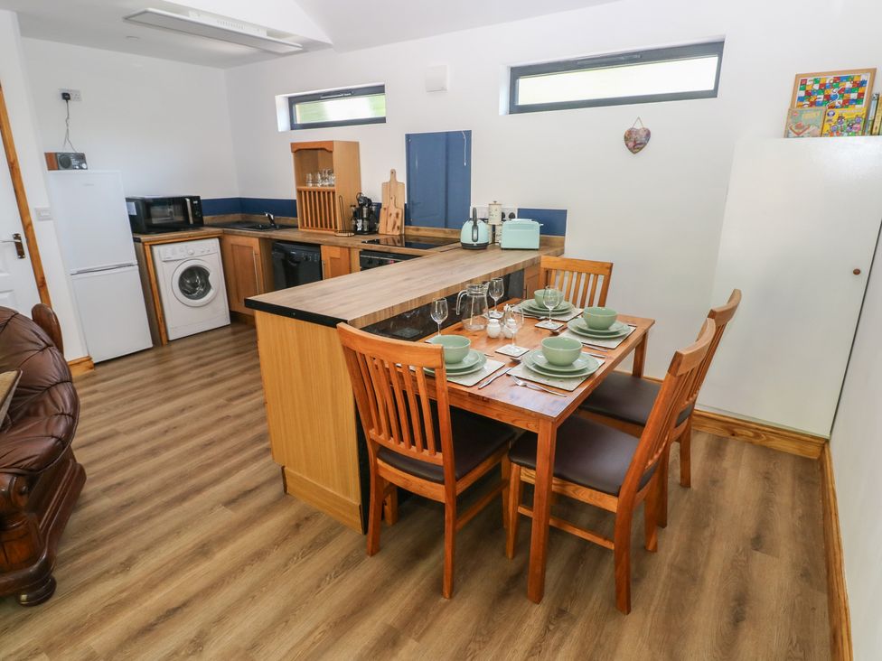 A kitchen with dining area and appliances at Brookview Kingfisher in Haverfordwest