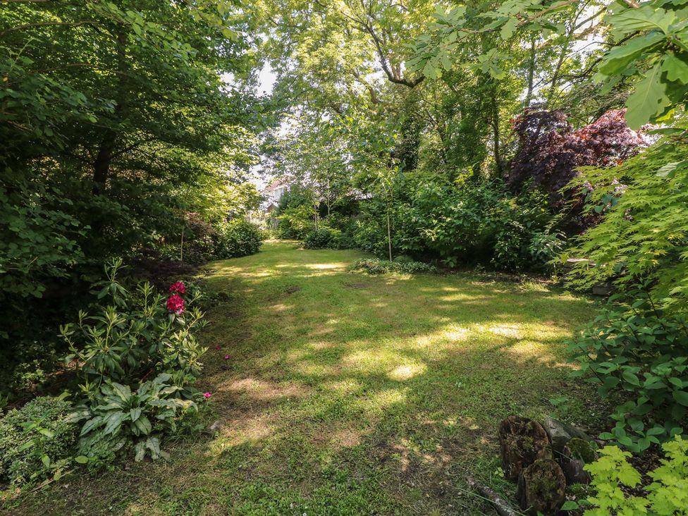 A garden with grass and trees at Brookview Kingfisher in Haverfordwest