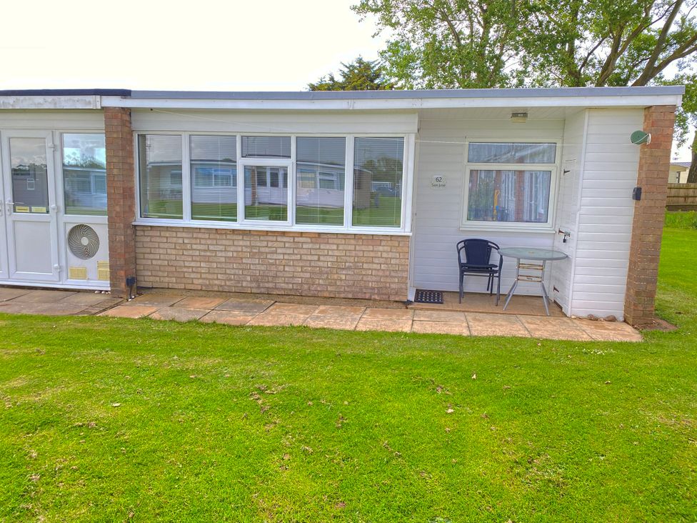 An outdoor area with a table and chair at Chalet 62 California, Norfolk