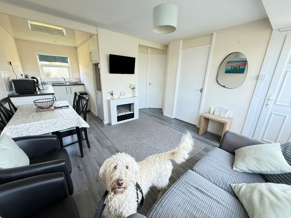 A living room with a table and chairs at Chalet 62, California, Norfolk