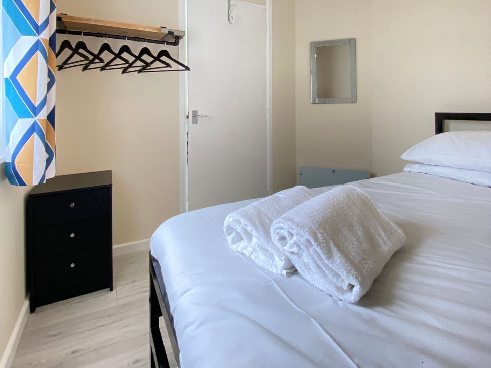 A bedroom with a bed and towels on it at Chalet 62 in California, Norfolk