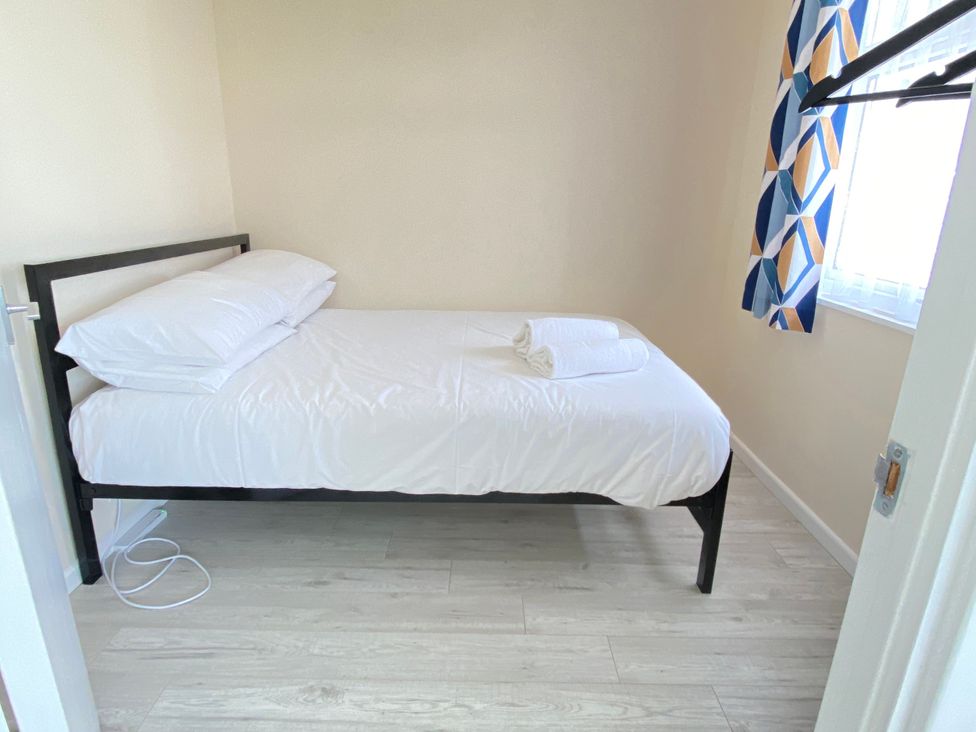 A bedroom with a bed and window at Chalet 62 California, Norfolk