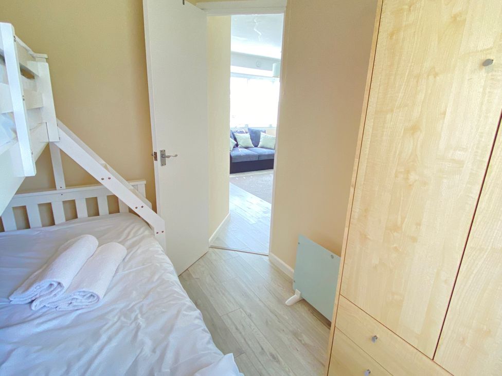 A bedroom with a bunk bed and towels at Chalet 62 California, Norfolk