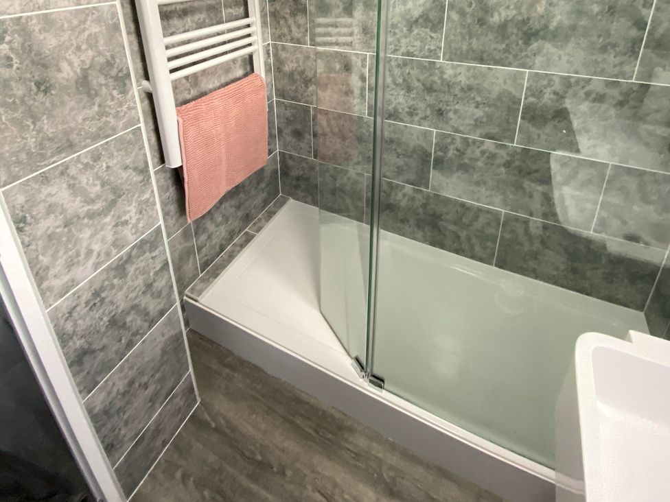 A bathroom with a shower and towel rack at Chalet 57 in California, Norfolk