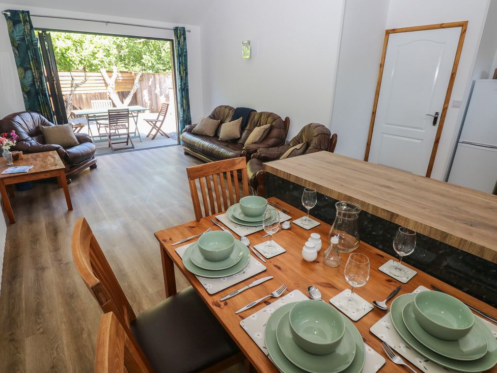 A dining room with a table set for dinner at Brookview Goldfinch in Haverfordwest