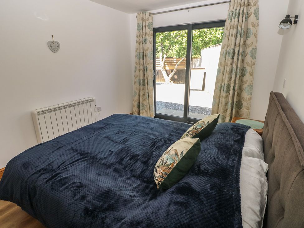 A bedroom with a bed and window at Brookview Goldfinch in Haverfordwest