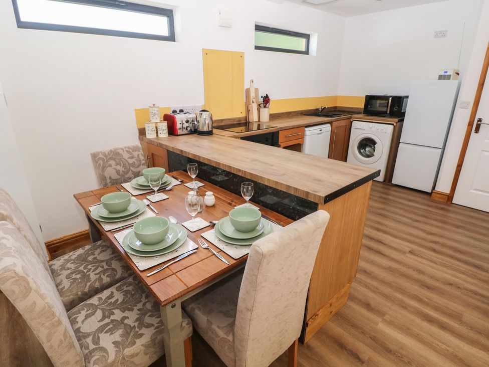 A kitchen with dining table and chairs at Brookview Goldfinch in Haverfordwest