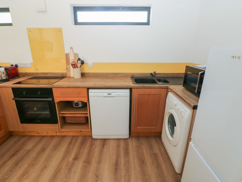 A kitchen with appliances and countertops at Brookview Goldfinch in Haverfordwest