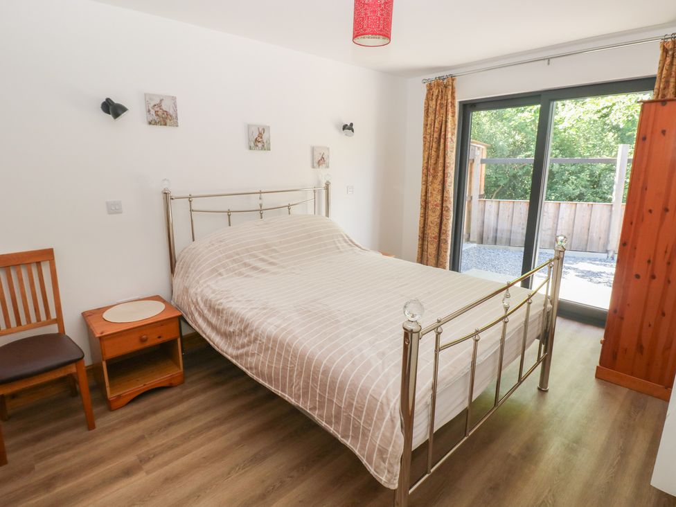 A bedroom with a bed and side table at Brookview Goldfinch in Haverfordwest