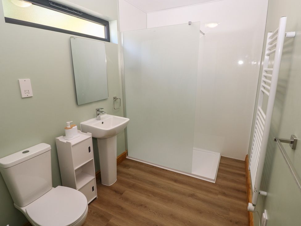 A bathroom with a sink, toilet and shower at Brookview Goldfinch in Haverfordwest