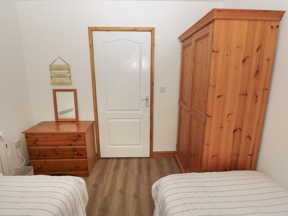 A bedroom with a wardrobe and chest of drawers at Brookview Goldfinch Haverfordwest