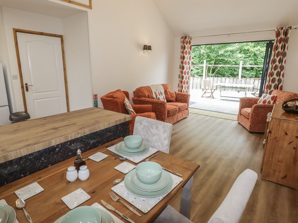 A living room with a dining table and seating area at Brookview Goldfinch in Haverfordwest