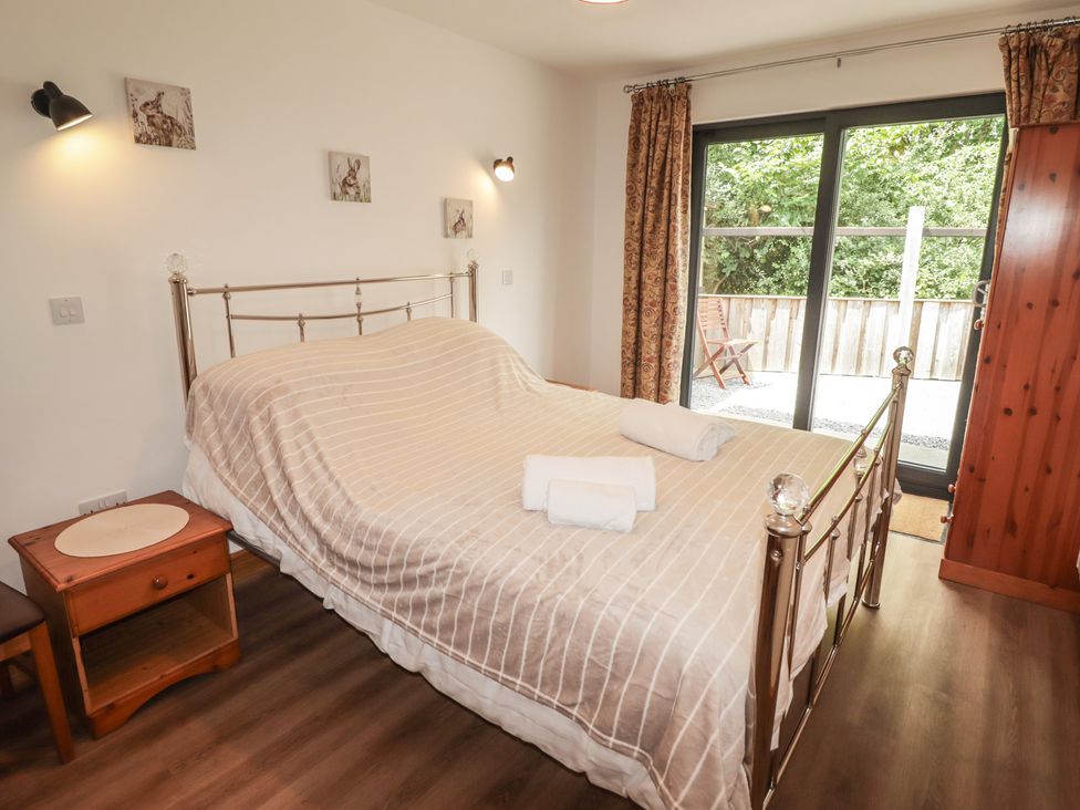 A bedroom with a bed and bedside table at Brookview Goldfinch in Haverfordwest