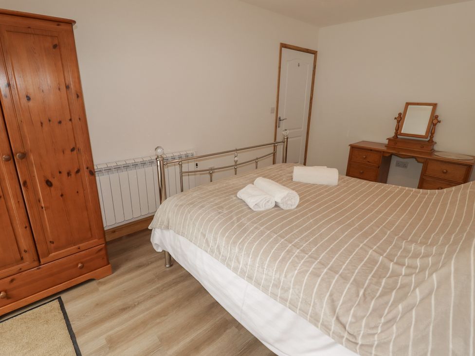 A bedroom with a bed and wardrobe at Brookview Goldfinch in Haverfordwest
