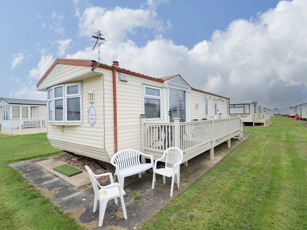 A caravan with decking and chairs at Towervans Z11 in Mablethorpe