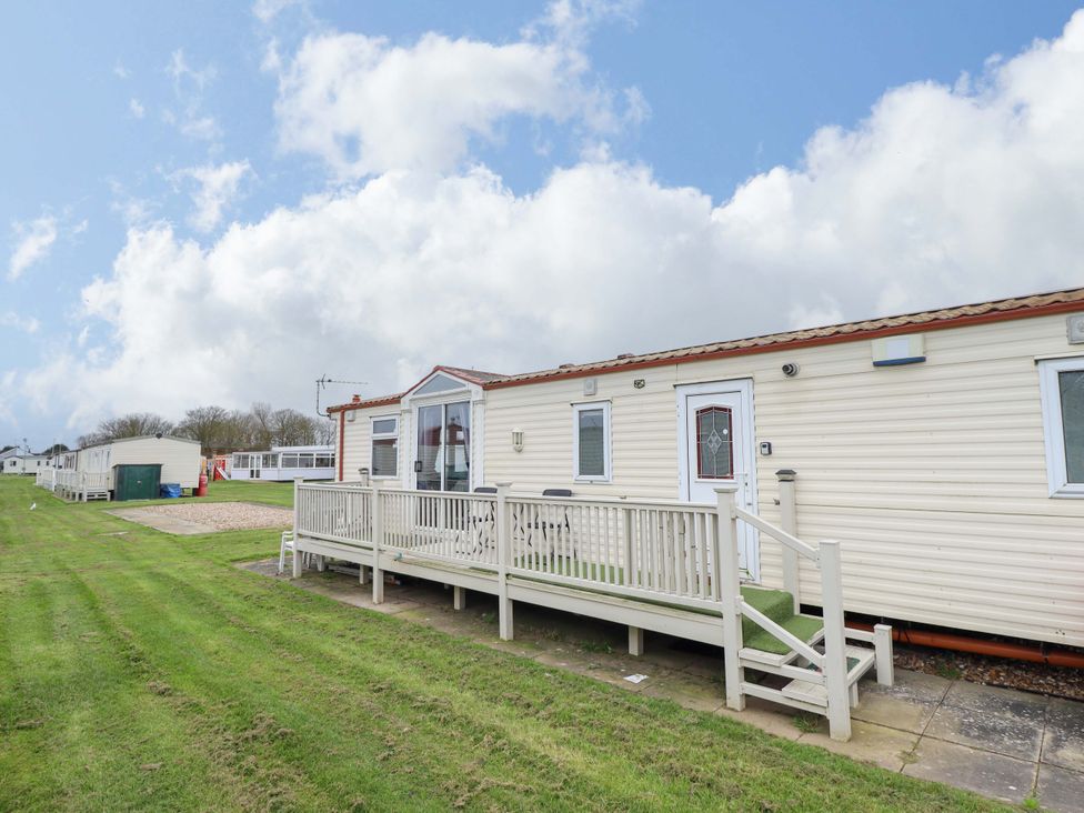 A mobile home with a deck and steps at Towervans Z11 in Mablethorpe