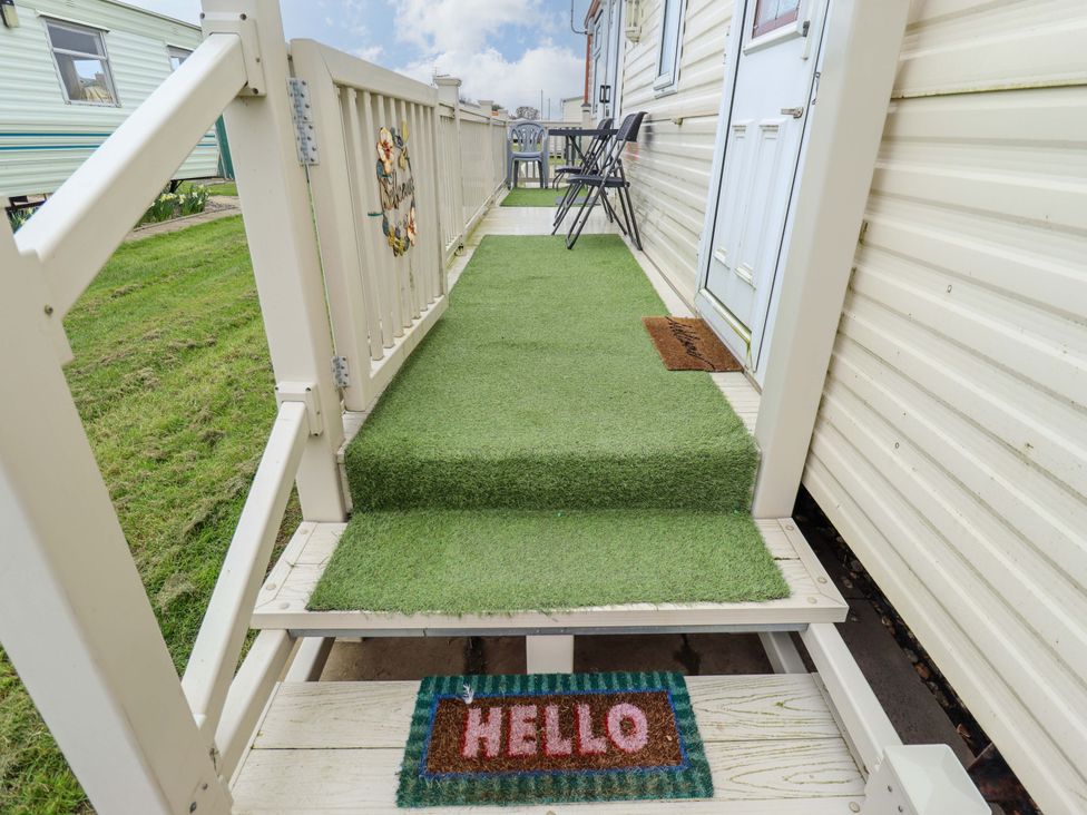 A porch with steps and a welcome mat at Towervans Z11 Mablethorpe