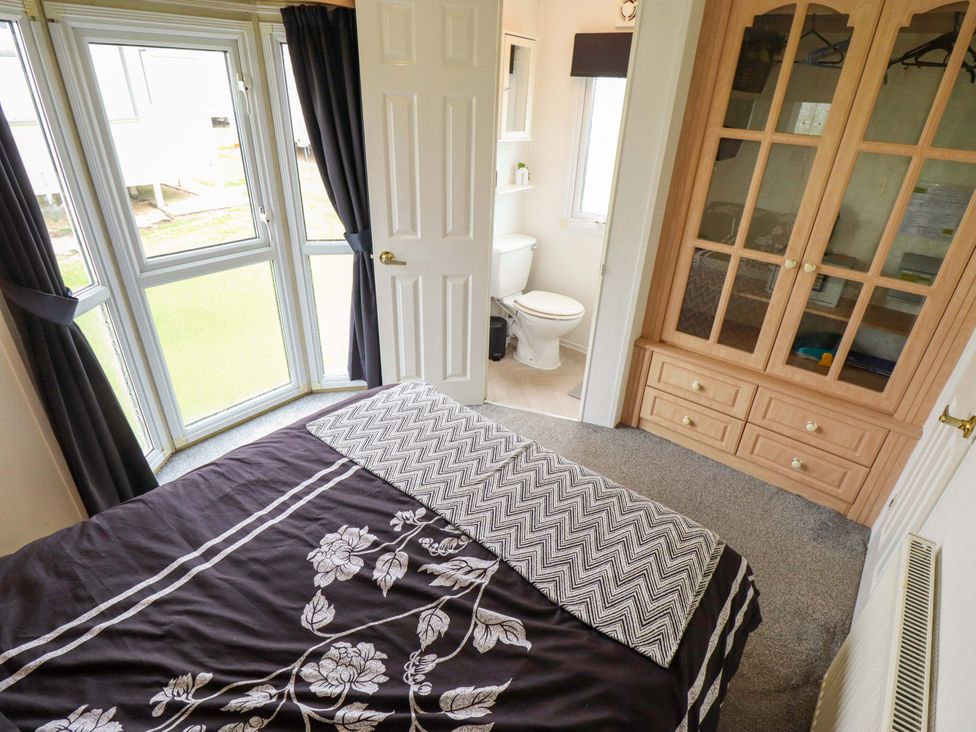 A bedroom with a bed and closet at Towervans Z11 in Mablethorpe