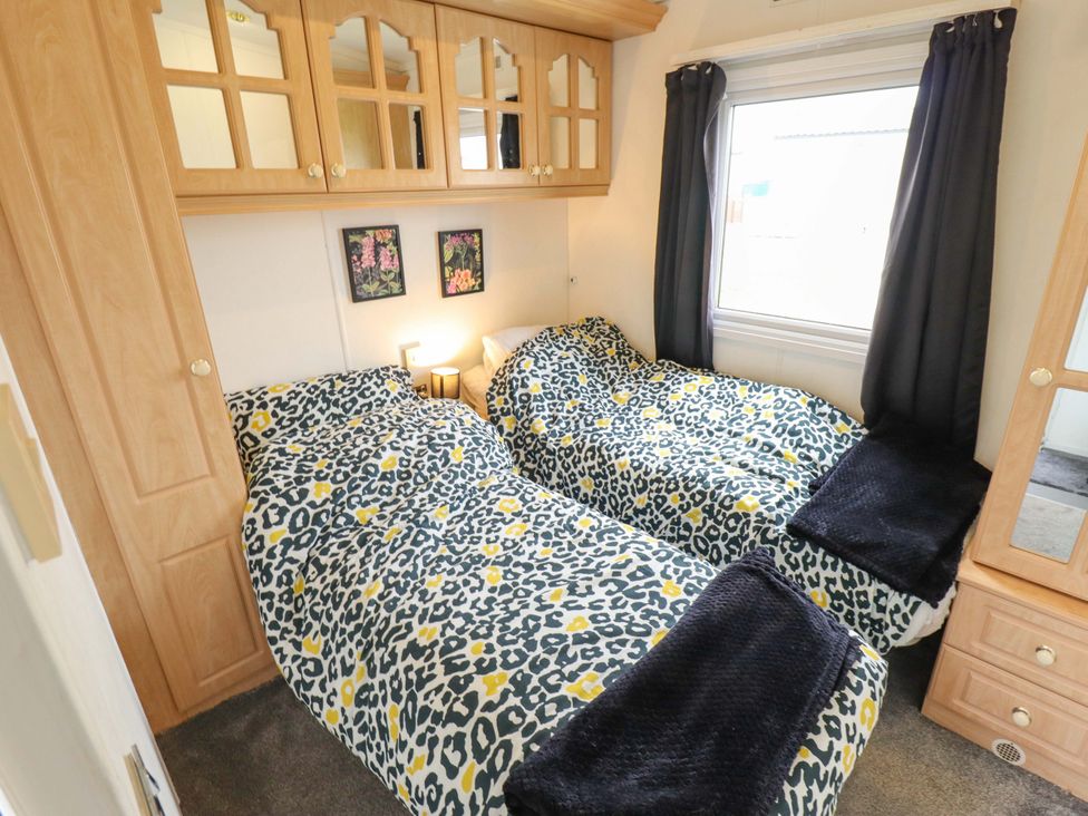 A bedroom with twin beds and a wardrobe at Towervans Z11 in Mablethorpe