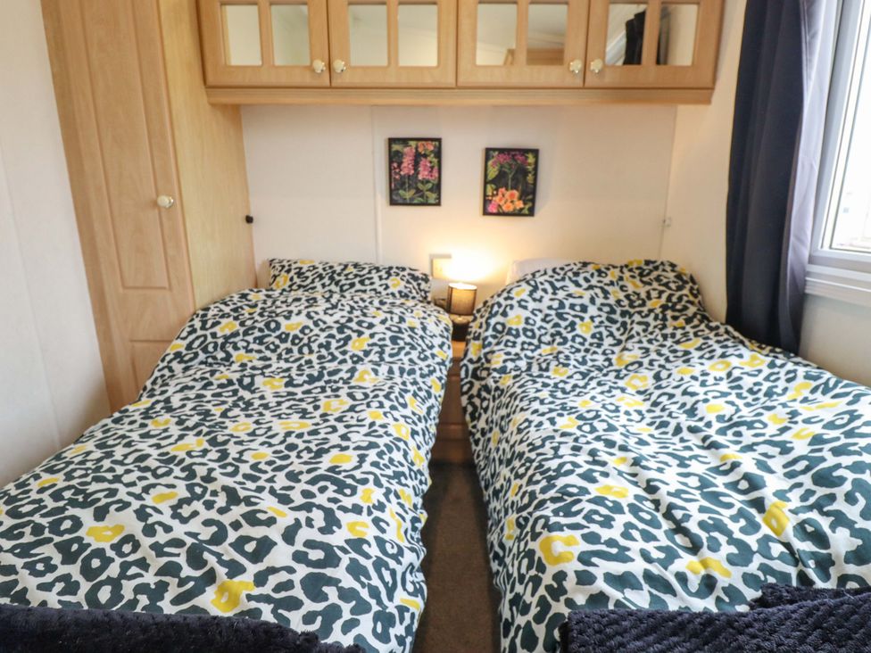 A bedroom with two single beds and a wardrobe at Towervans Z11 in Mablethorpe