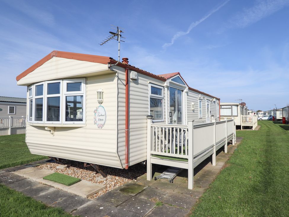 A caravan with a decking area at Towervans Z11 in Mablethorpe