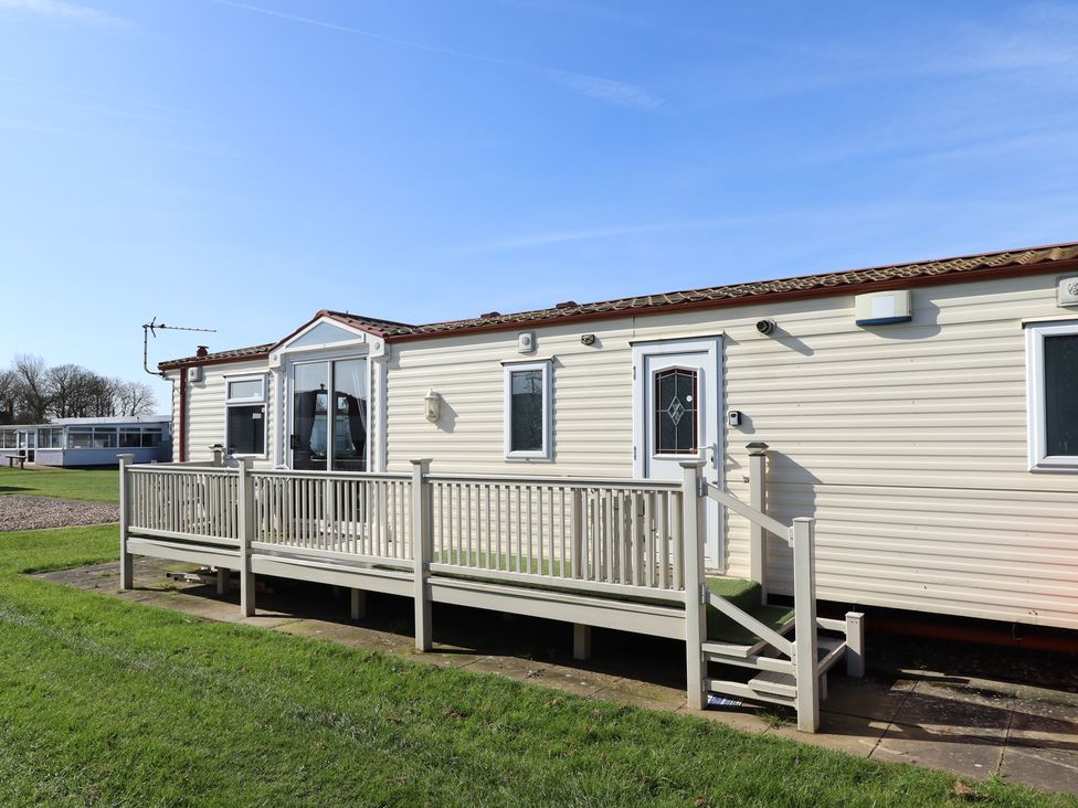 A mobile home with a deck and steps at Towervans Z11 in Mablethorpe