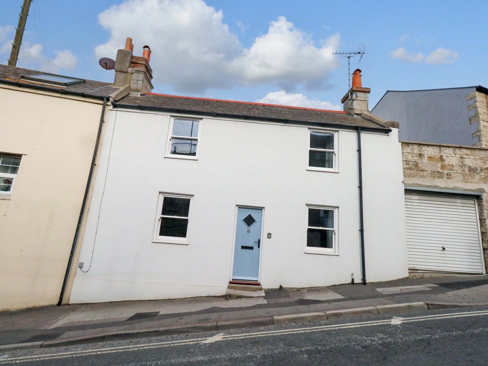 A house with a blue door and white walls at NO 10 in Fortuneswell