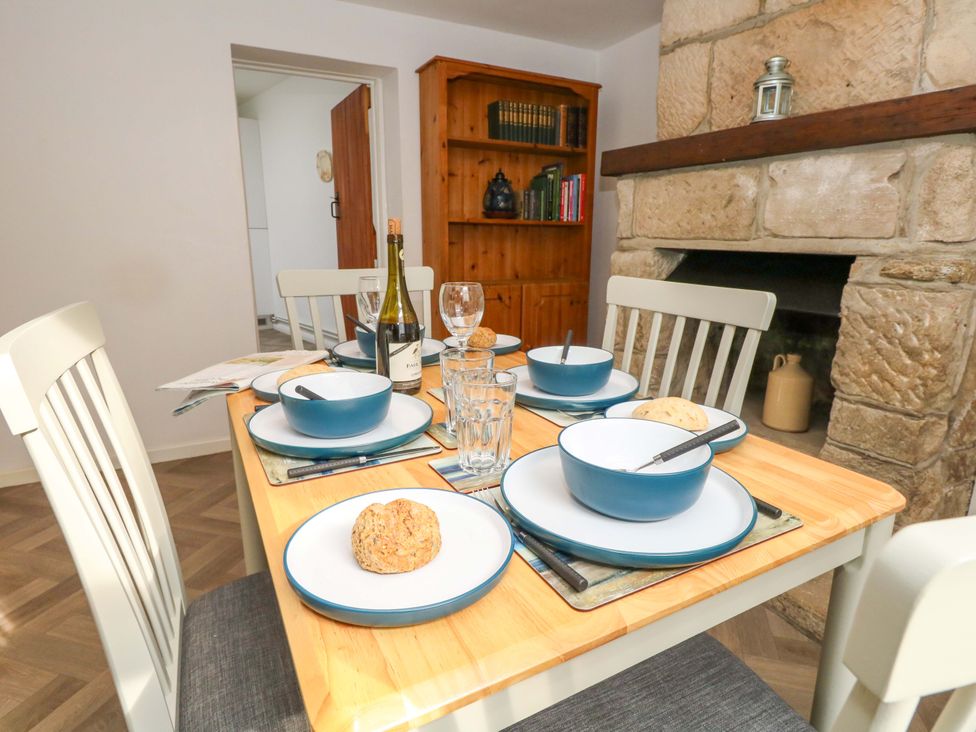 A dining room with a table set for a meal at NO 10 Fortuneswell