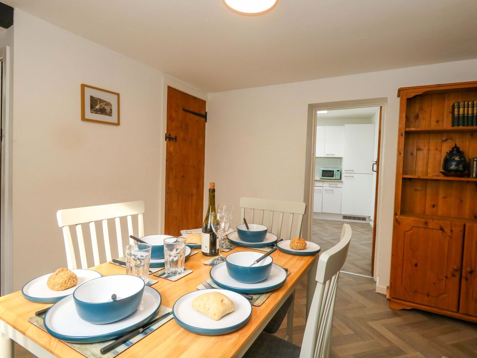 A dining room with a table set for meals at NO 10 Fortuneswell