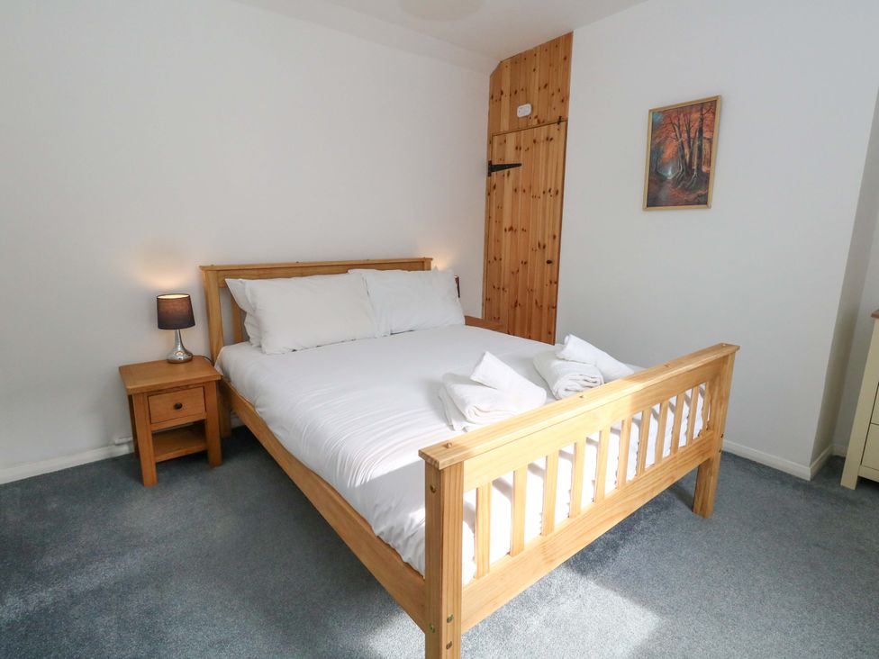 A bedroom with a bed and nightstand at NO 10 in Fortuneswell