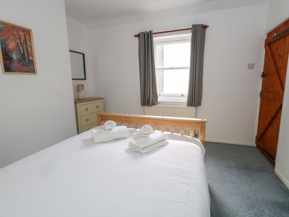 A bedroom with a bed and dresser at NO 10 Fortuneswell