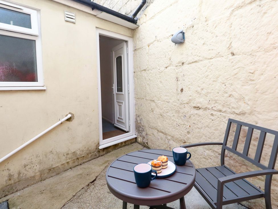 A small outdoor area with a table and chairs at NO 10 Fortuneswell