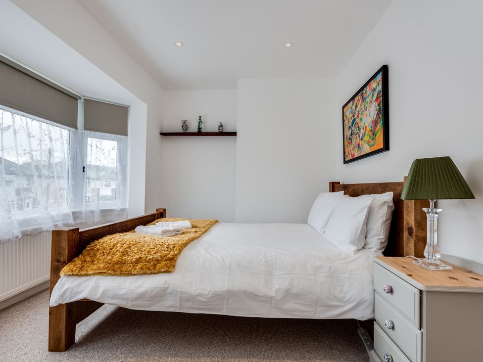 A bedroom featuring a bed, bedside table, and window at Florence of Oxford, Oxford