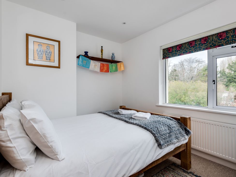 A bedroom with a bed and decorative items on a shelf at Florence of Oxford, Oxford