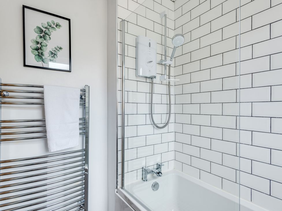A bathroom with a shower, bathtub, and towel rack at Florence of Oxford in Oxford
