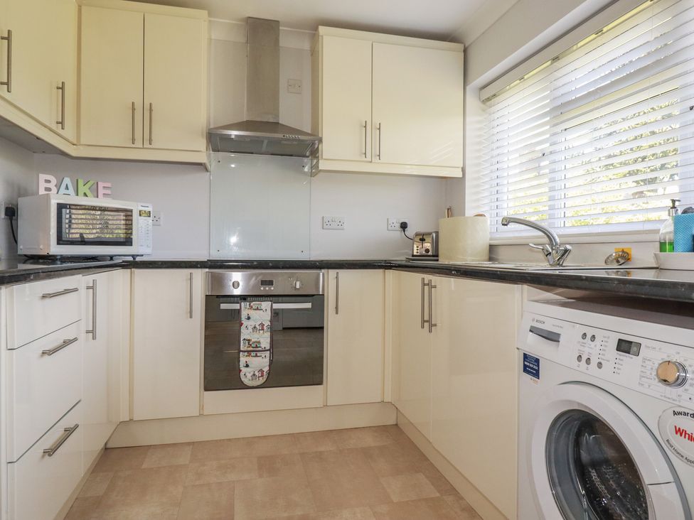 A kitchen with appliances and cabinets at Tregoning annex in Lerryn near Lostwithiel
