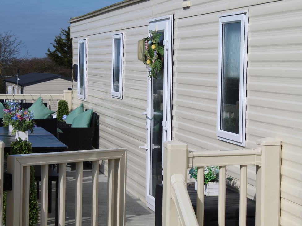 A balcony with table and chairs at Kent Coast Holiday Park - Holiday Accommodation 22252, Rochester, Kent