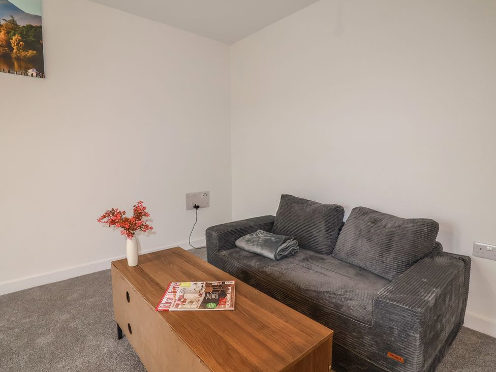 A living room with a sofa and coffee table at Apartment 7 at Anfield in Liverpool