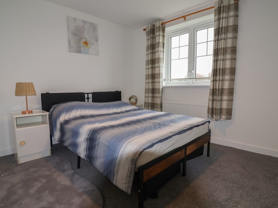 A bedroom with a bed and nightstand at Apartment 7 at Anfield Liverpool