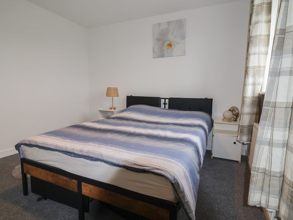 A bedroom with a bed and side table at Apartment 7 at Anfield Liverpool