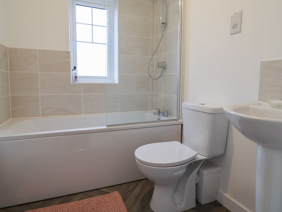 A bathroom with a shower over the bathtub and a sink at Apartment 7 at Anfield Liverpool
