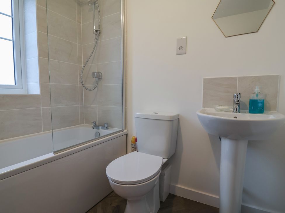 A bathroom with a bathtub, shower, sink, and toilet at Apartment 7 at Anfield, Liverpool
