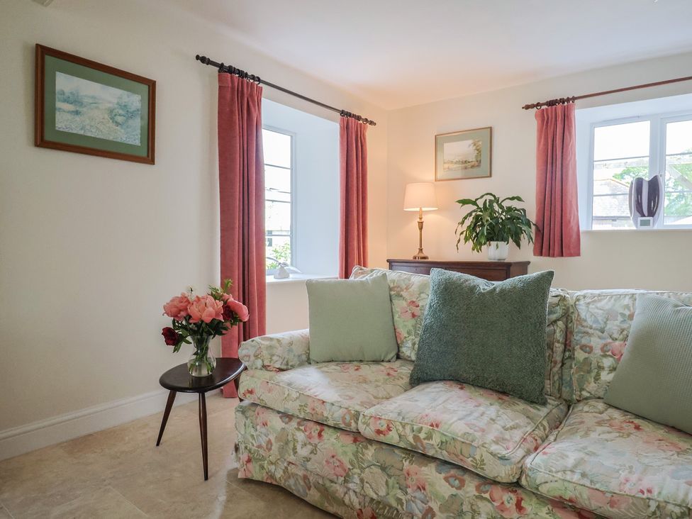 A living room with a sofa and curtains at Harbins Farm in Glanvilles Wootton Nr. Sherborne